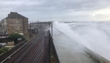 Trains cancelled as waves crash onto overhead wires