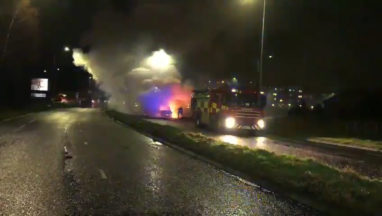 Firefighters extinguish car after it bursts into flames