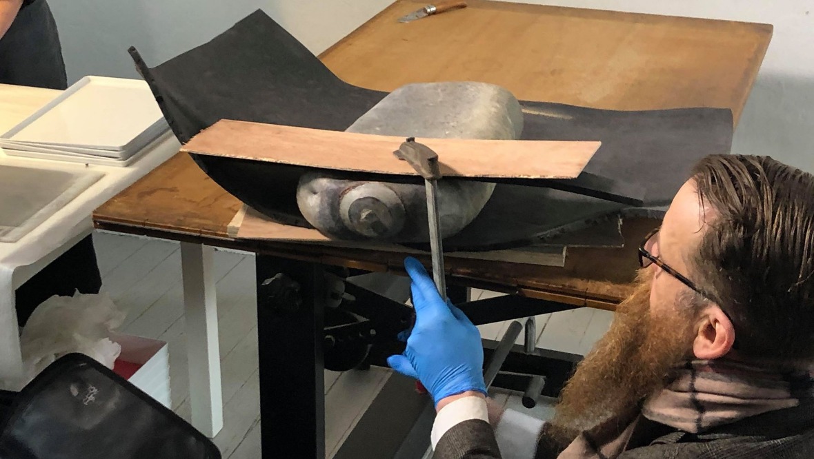 Conservator: Nic Boyes examines the capsule