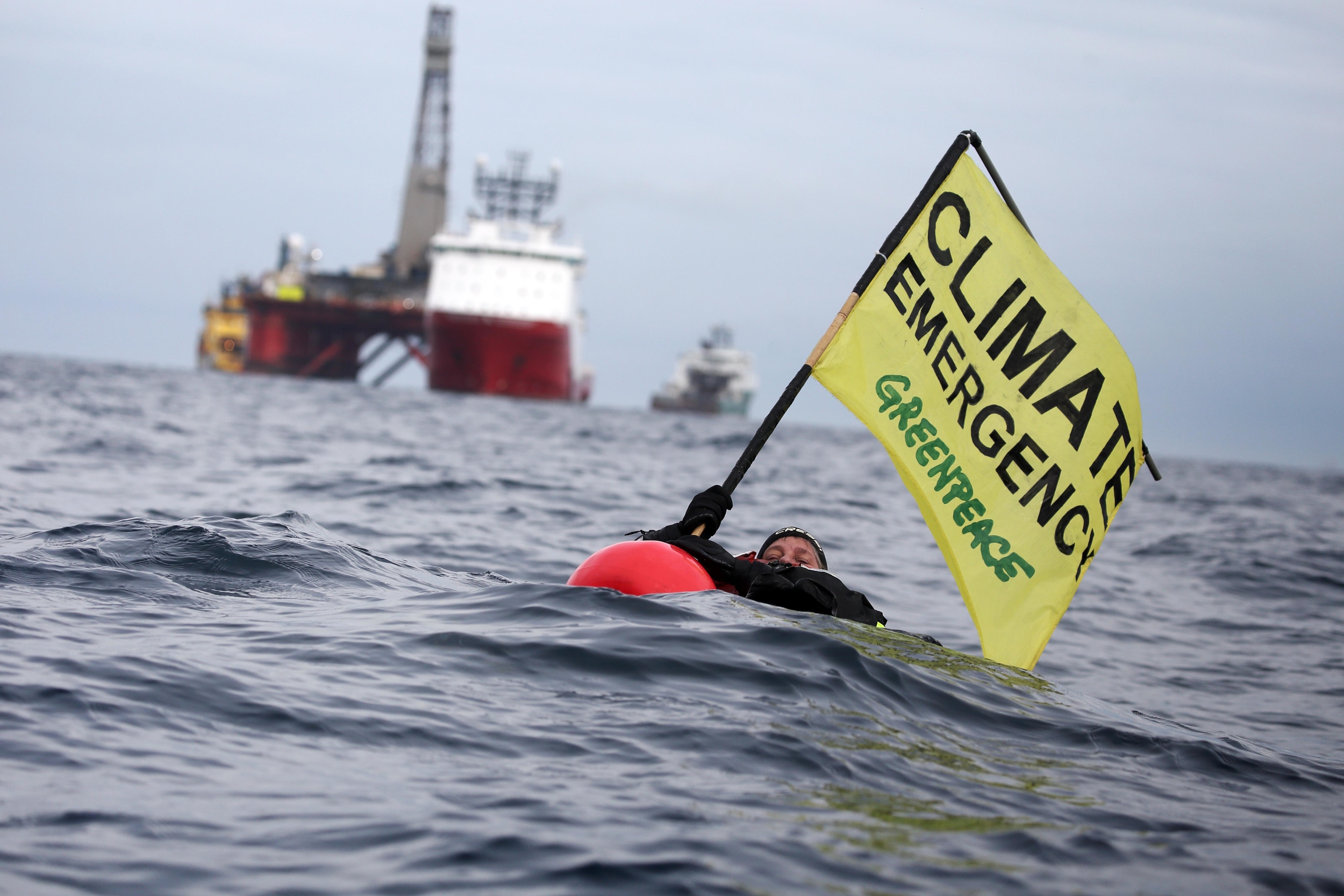 North Sea: A campaigner holds a 'climate emergency' banner.