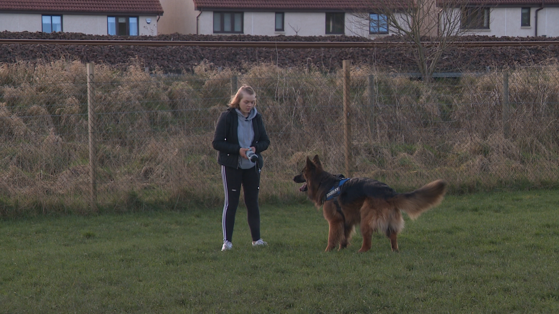 Kira celebrates her latest results by playing with dog Milo.