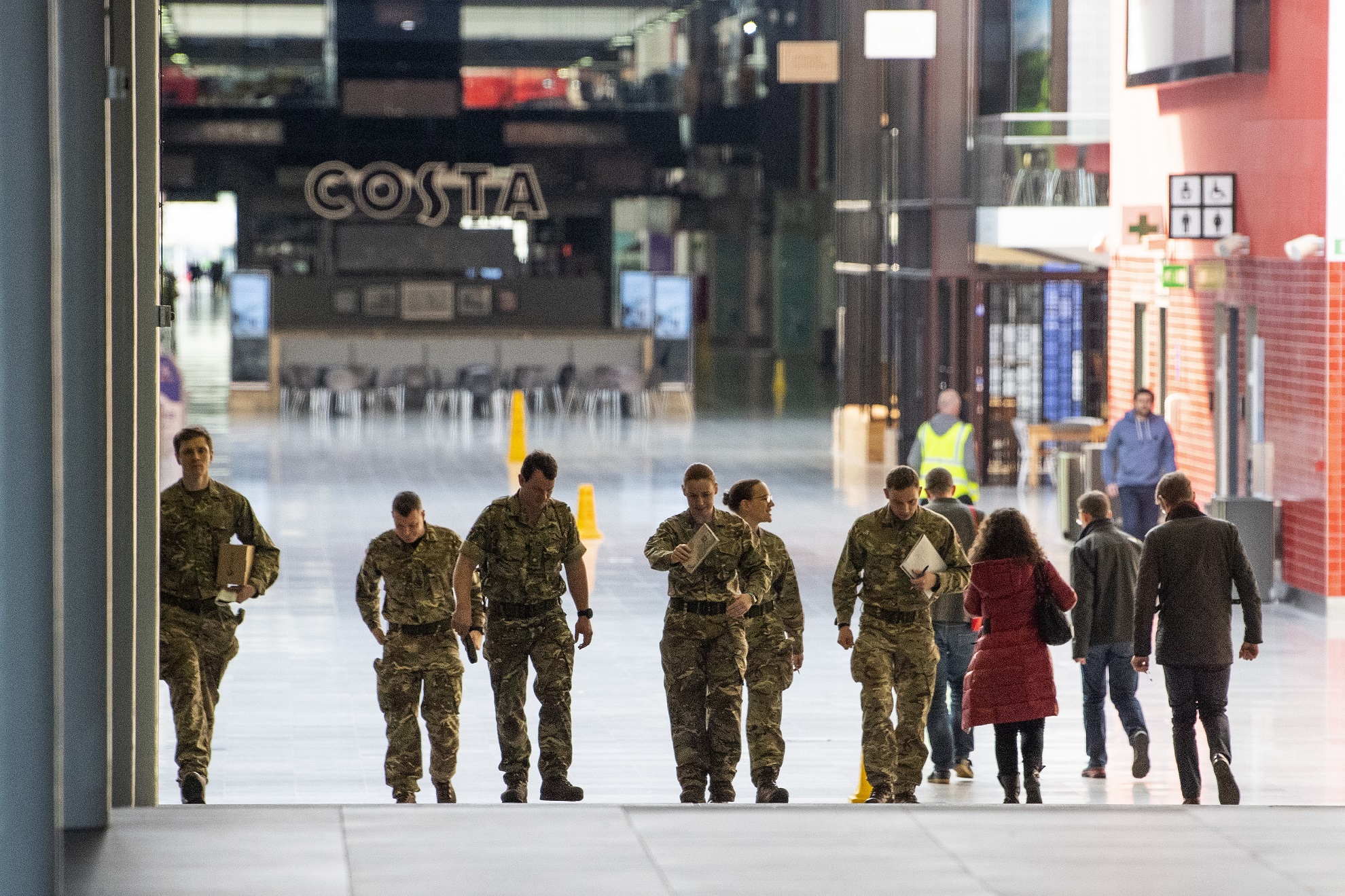 Military personnel walk inside the Excel Centre in London, which is to be a field hospital