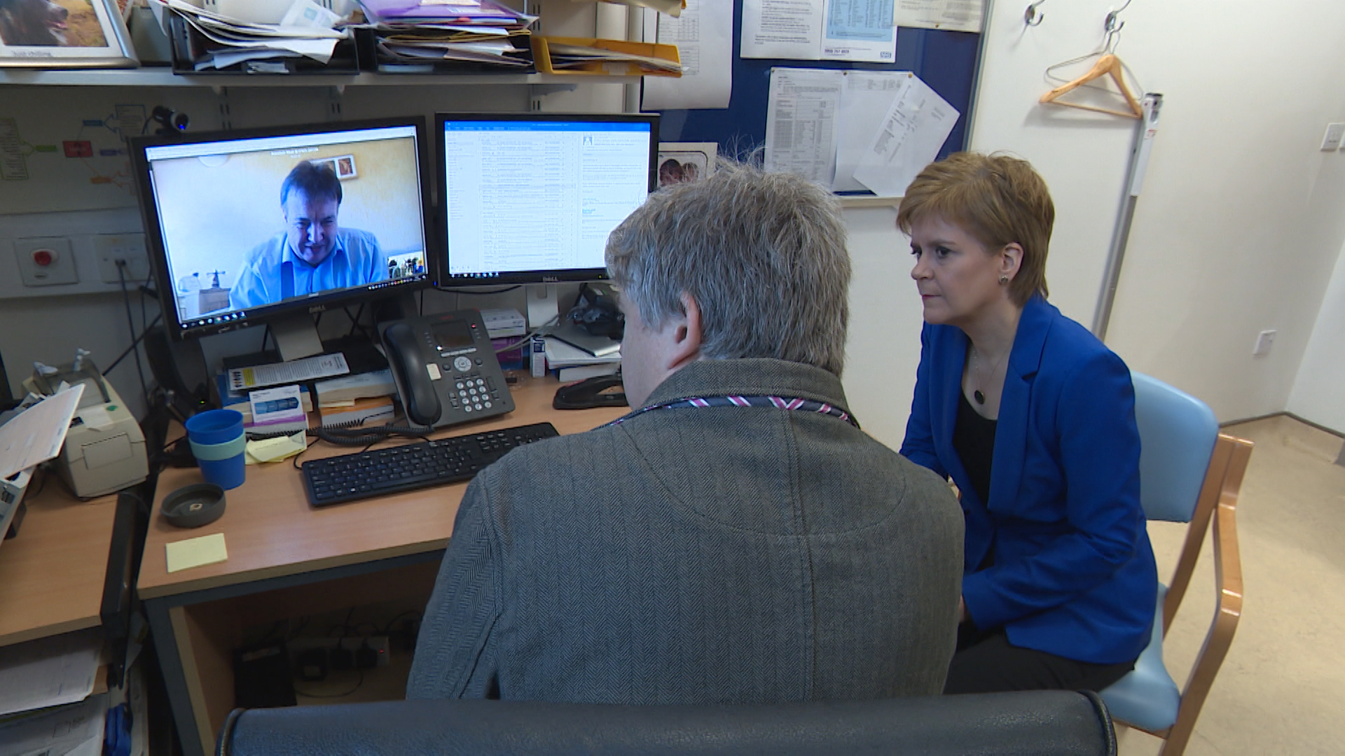 Nicola Sturgeon looks at coronavirus video consultations in Edinburgh.
