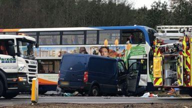 Van driver dies and seven in hospital after bus crash
