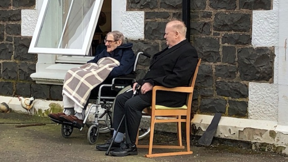 Audience: Residents have been taking chairs outside or listening from bedroom windows. 