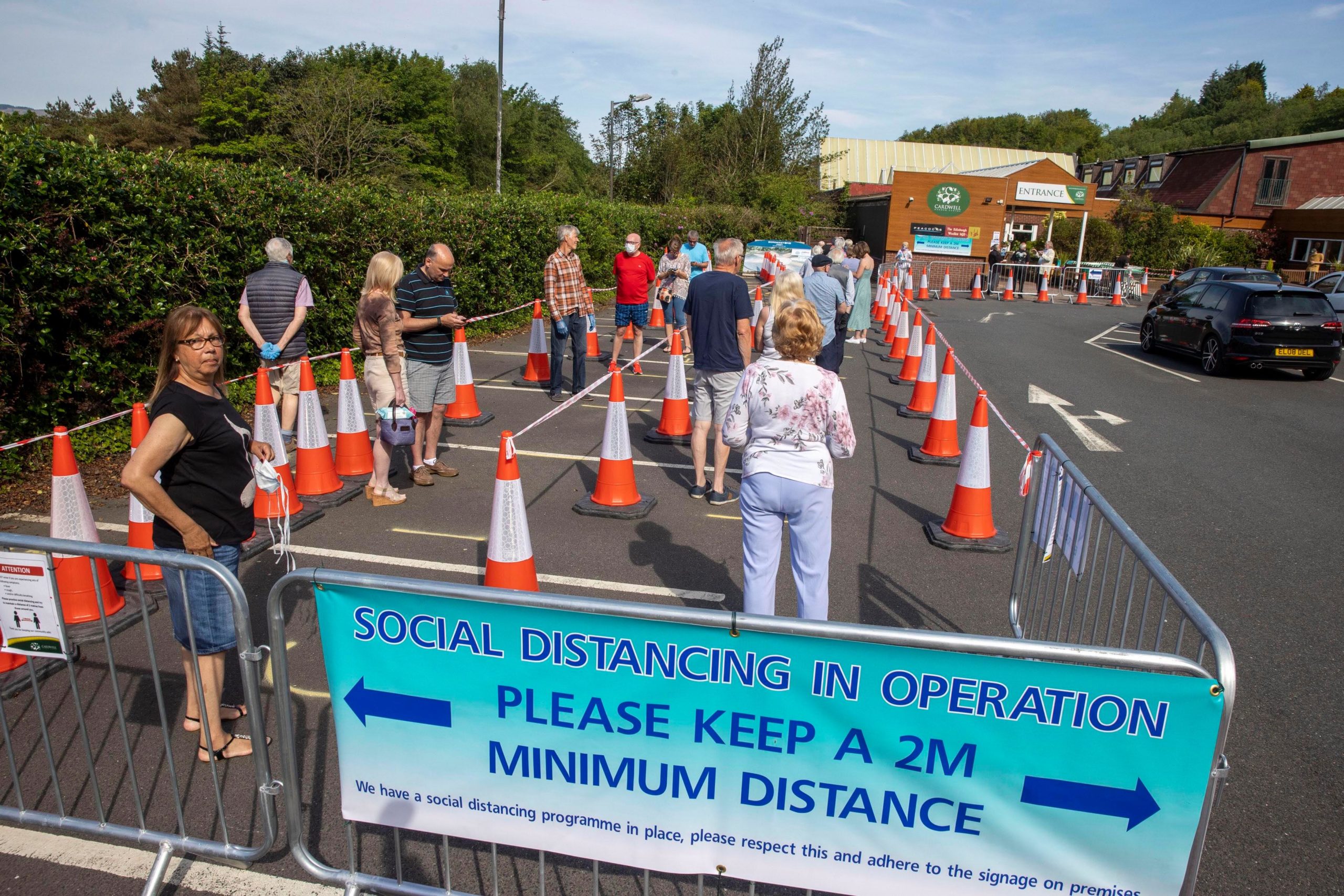 Shoppers queue outside the garden centre.