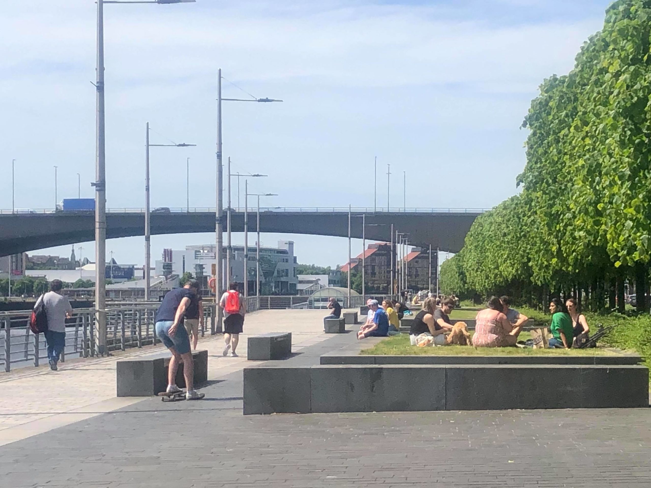 Locals soak up the sun next to the Clyde.