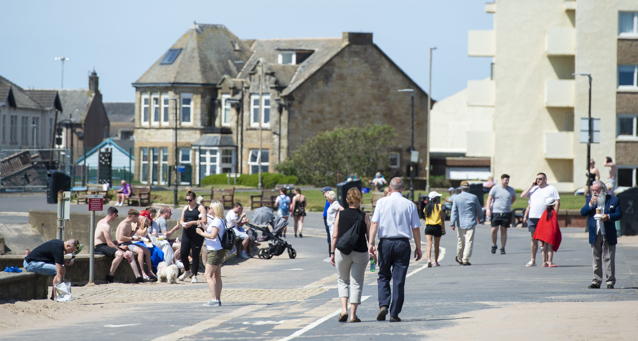 Locals gather next to the seaside. SNS Group.