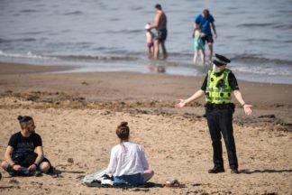 Police intervene after crowds gather at beach on hottest day