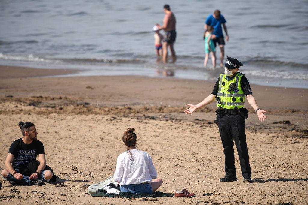 Officer remonstrating with people at Portobello Beach on May 20, 2020.