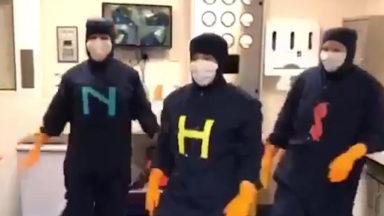 NHS technicians break into dance wearing full aseptic suits