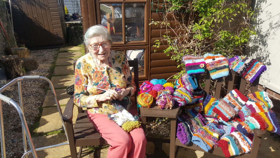 Super-knitter making twiddle muffs for dementia charity