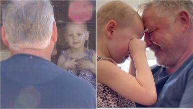 Child with cancer reunites with dad after seven weeks apart
