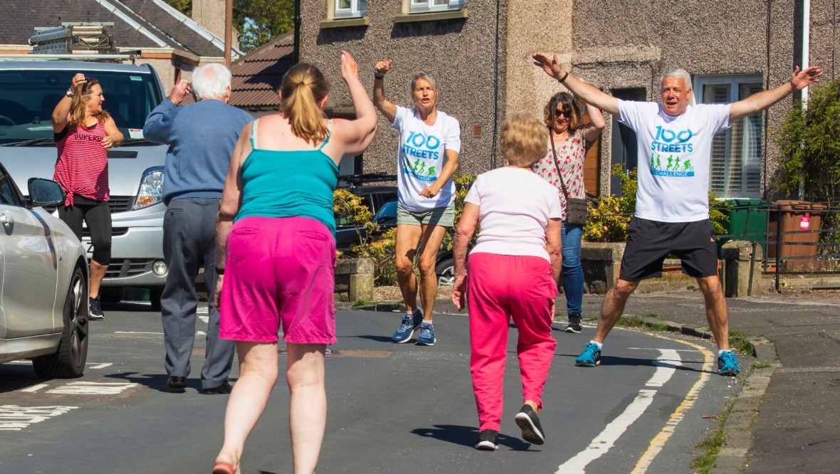 Keeping fit: Scott and Jenny leading the class for their neighbours. <strong>SWNS</strong>” /><span class=