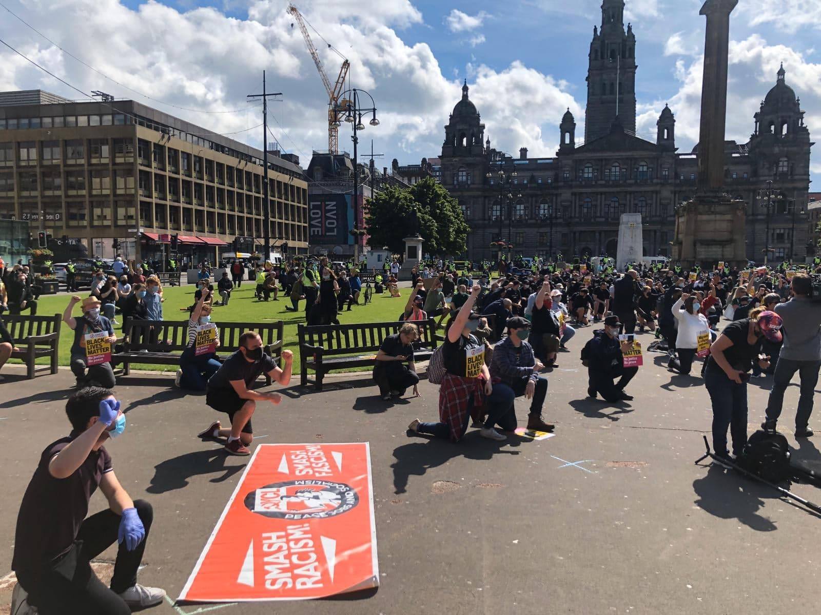 Protesters take a knee in demonstration.