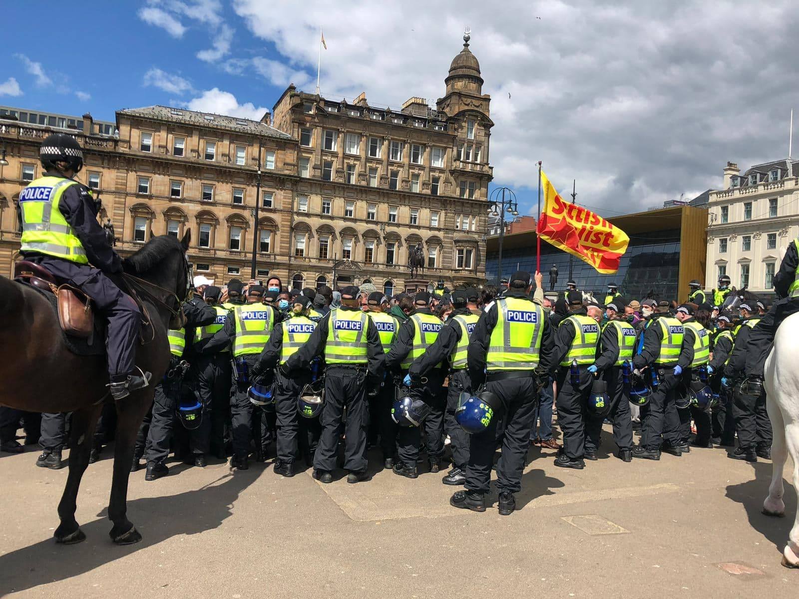 Police keeping protest groups apart during rally.