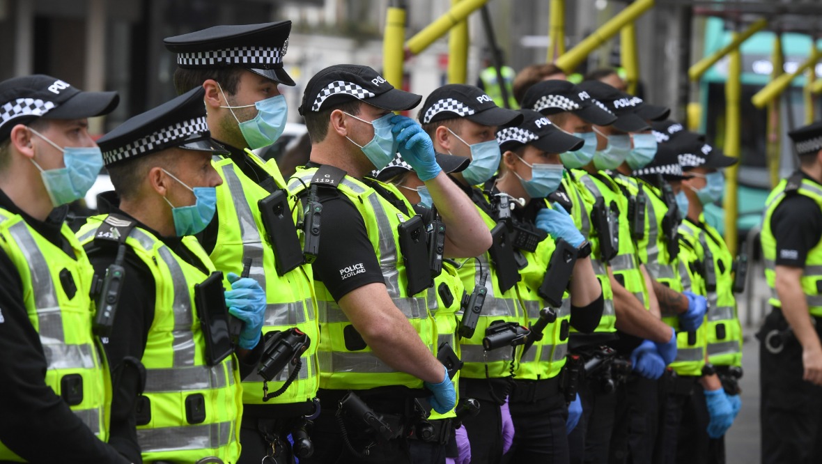 Police presence: Officers in George Square, Glasgow. <strong>SNS</strong>” /><span class=
