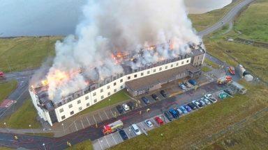 Firefighters tackle blaze as it tears through island hotel