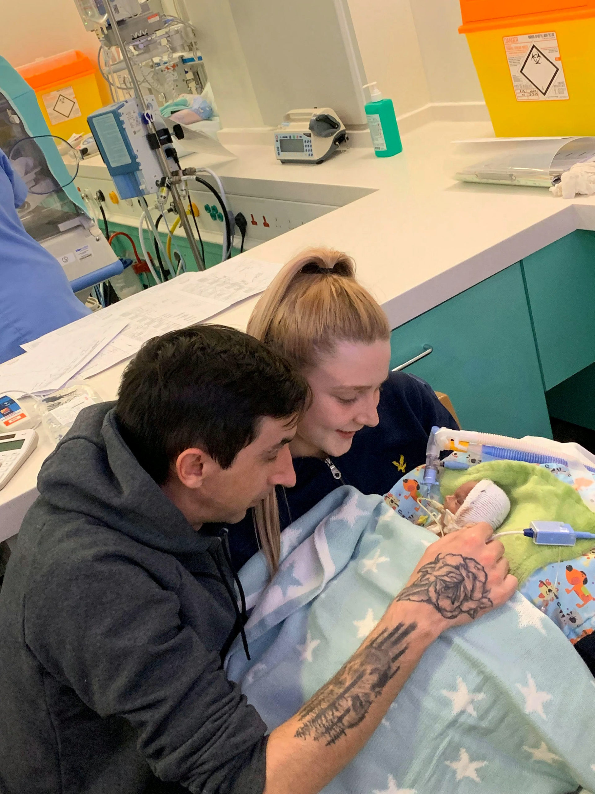 Ms Lugton and Mr McLachlan with Noah in hospital.