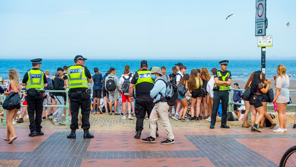 Police called to large disturbance on beach during heatwave