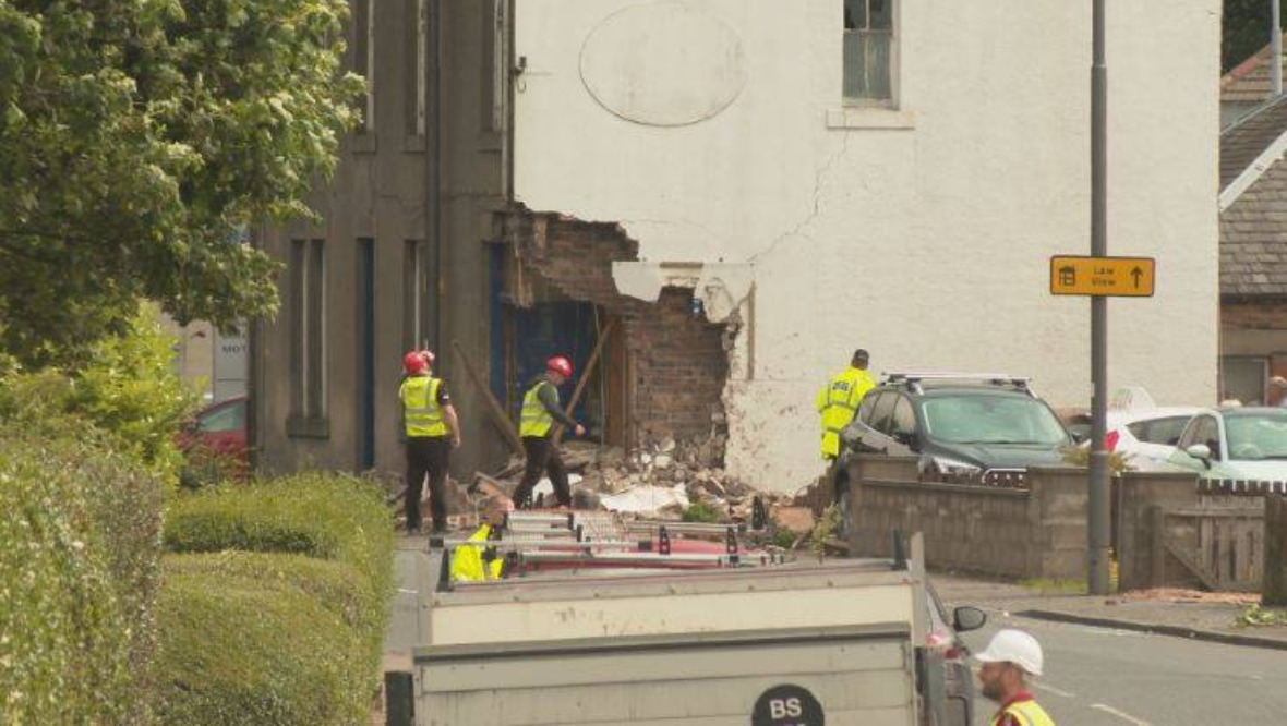 Two men who died after car ploughed into building named