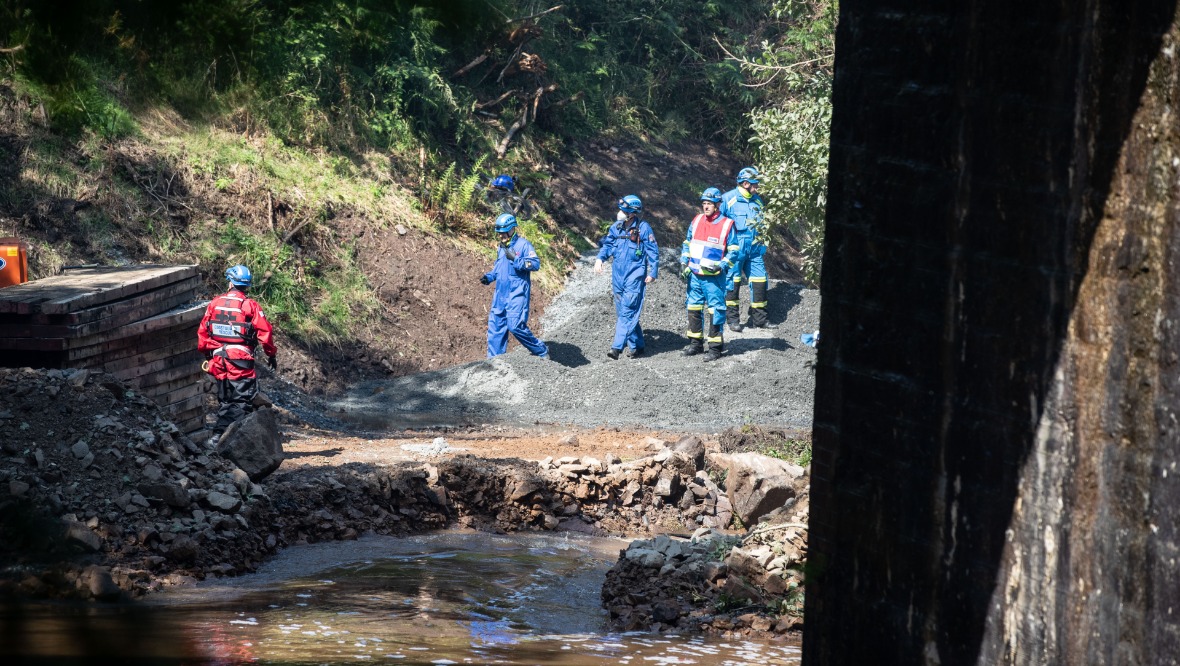 Rescuers make their way to the train. Pic: Newsline