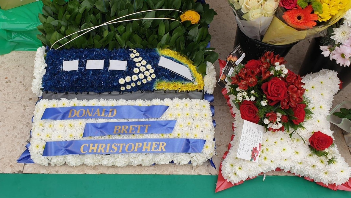 Floral tributes at Aberdeen train station during the minute's silence.