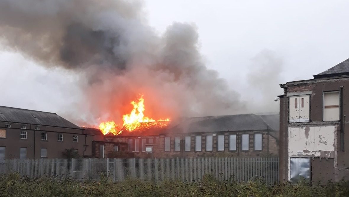 Blaze takes hold of old high school as fire crews respond