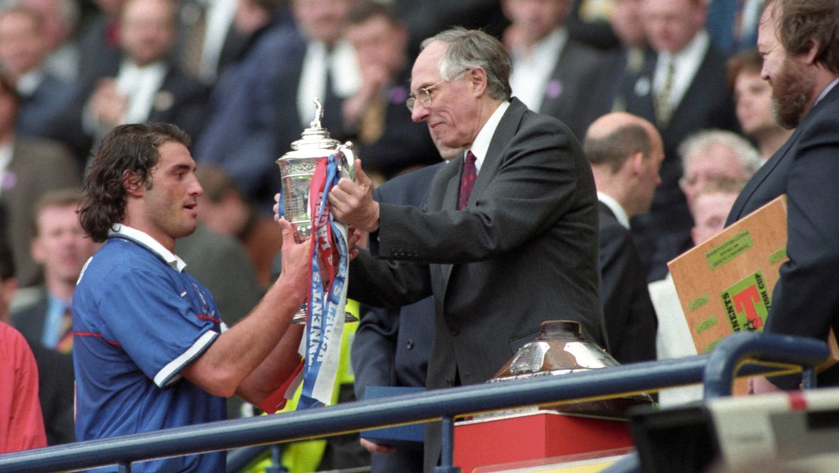 Donald Dewar presents the Scottish Cup to Rangers captain Lorenzo Amoruso.