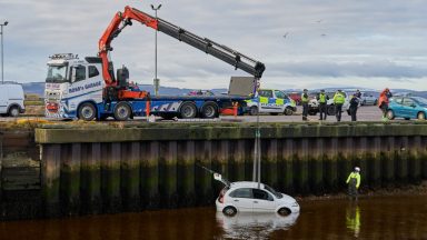 Man rescued from water after car plunges into harbour