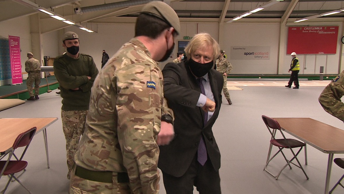 Boris Johnson bumps elbows with a serviceman in Castlemilk.