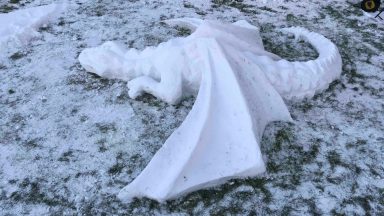 Face and body artist sculpts deadly-looking snow dragon