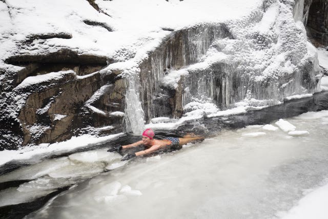  Alice takes a dip in the frozen waters of the River Calder, in the Cairngorms National Park.