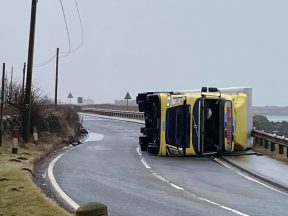 Main road closed after lorry overturns in high wind