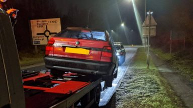 Recovery truck driver fined for car hanging off the back