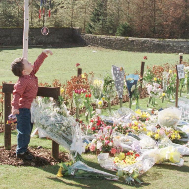 Memorial garden: Connor Clydesdale, aged three, reaches for the chimes.