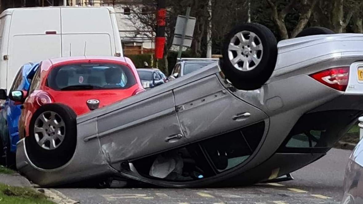 Car ends up on roof after crash on residential street