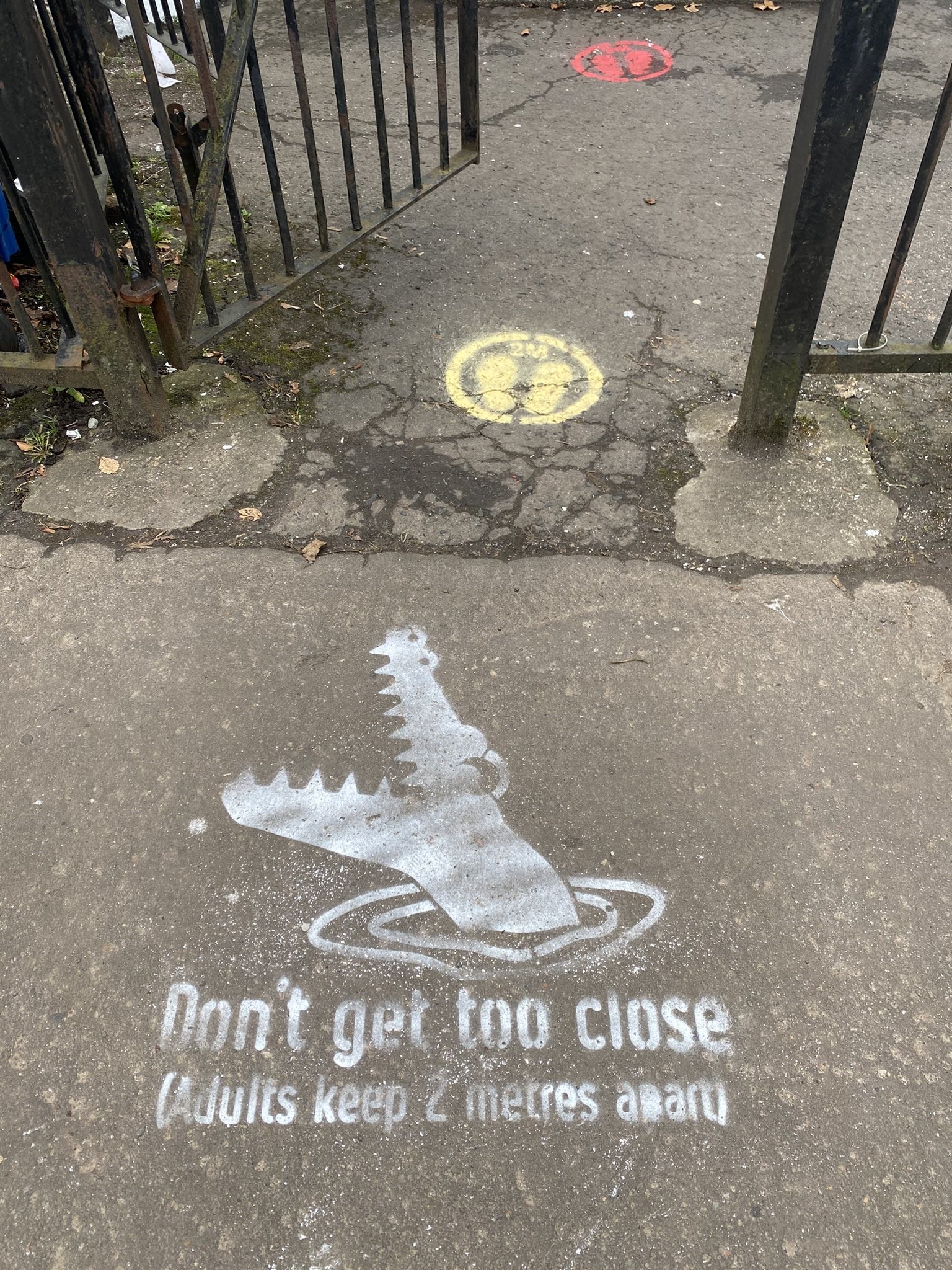 Crocodile stencil at the gate of a nursery where markings were already in place (Michelle Bonner)