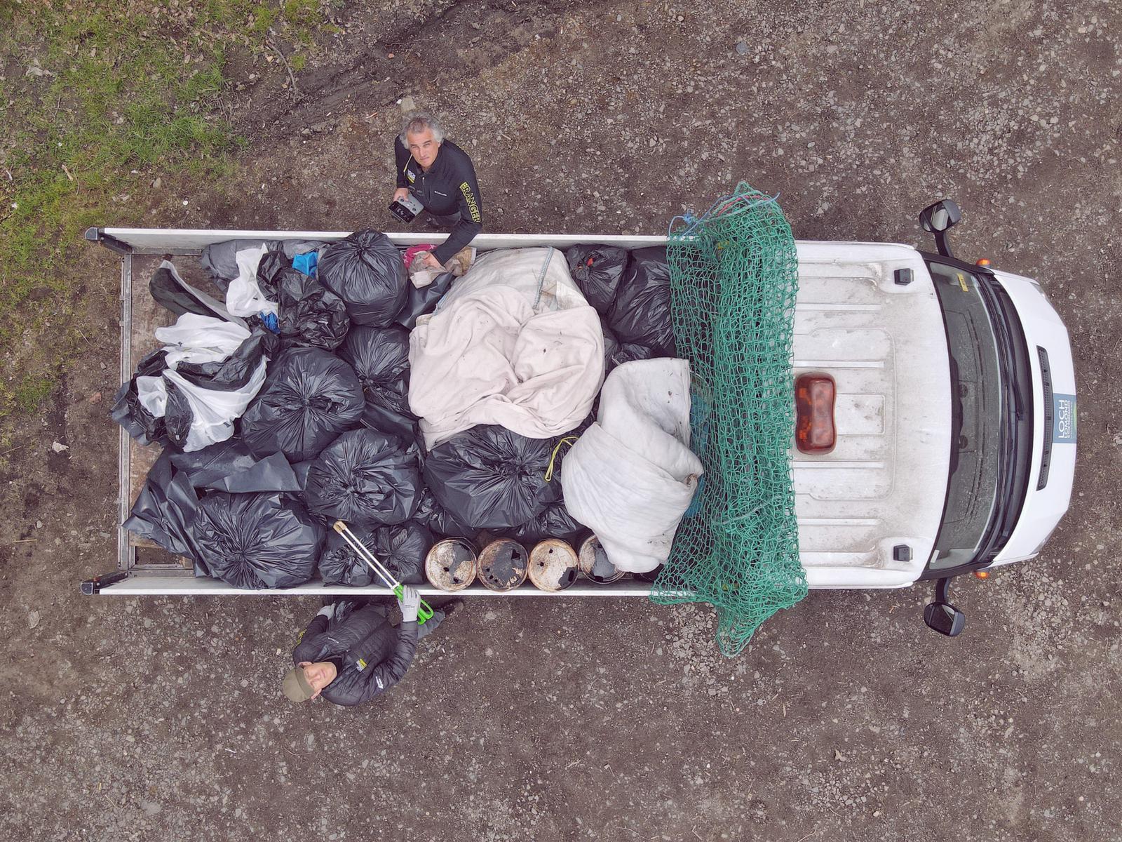 Park ranger's truck piled high with bags of waste.