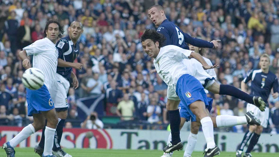 Kenny Miller steers his header home to put Scotland 1-0 in front against Italy.