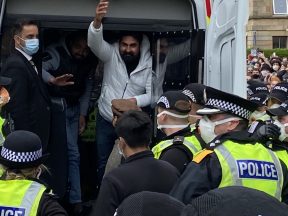 Police release men detained by immigration amid huge protest
