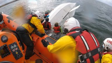Eight people rescued from water after dinghy capsized