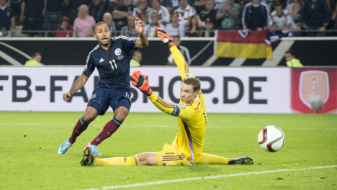 Ikechi Anya fires the ball past Manuel Neuer to equalise in Dortmund.