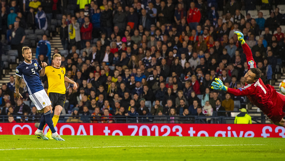  Kevin De Bruyne (right) makes it 4-0 as he curls beyond Scotland's David Marshall.