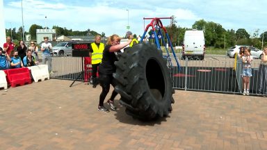 Woman smashes world record for flipping 20-stone tyre