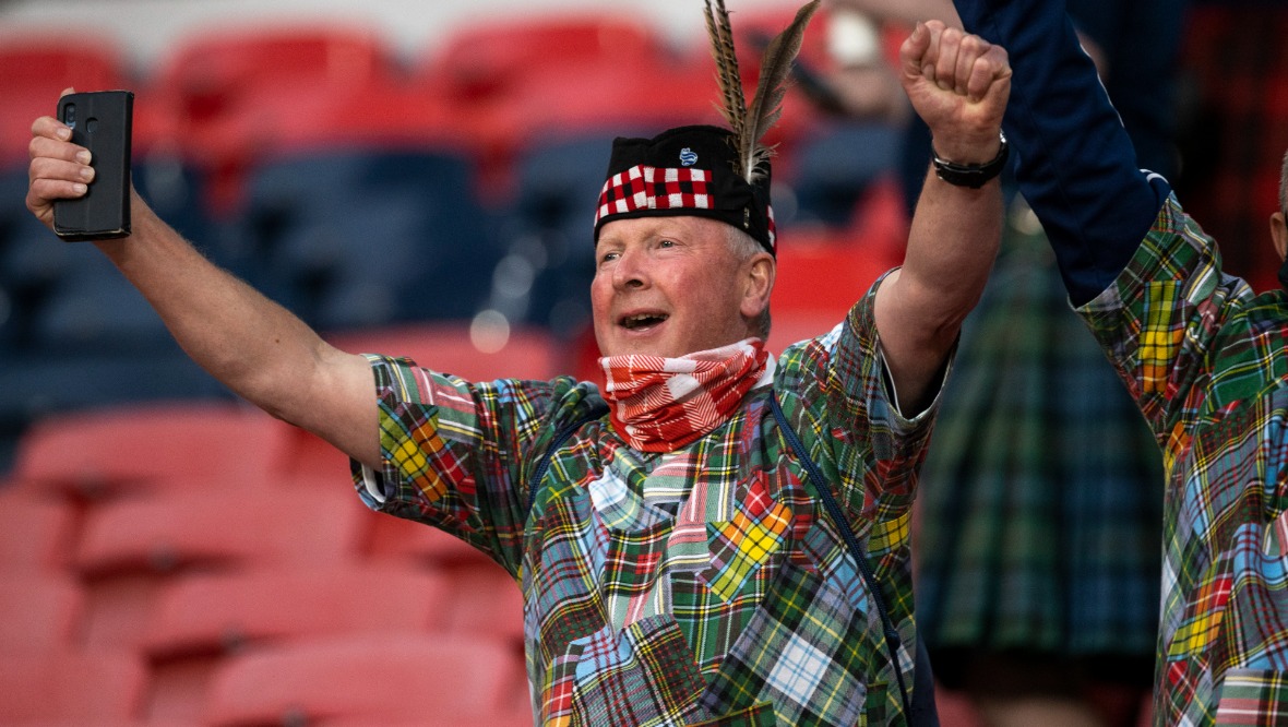 We'll be coming: Tartan Army fan in good spirits during the clash.