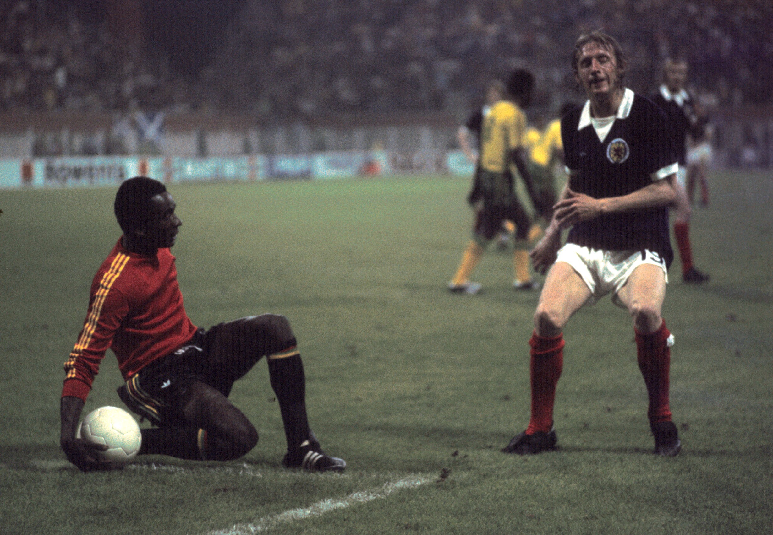 Zaire goalkeeper Muamba Kazadi gathers the ball at the feet of Denis Law