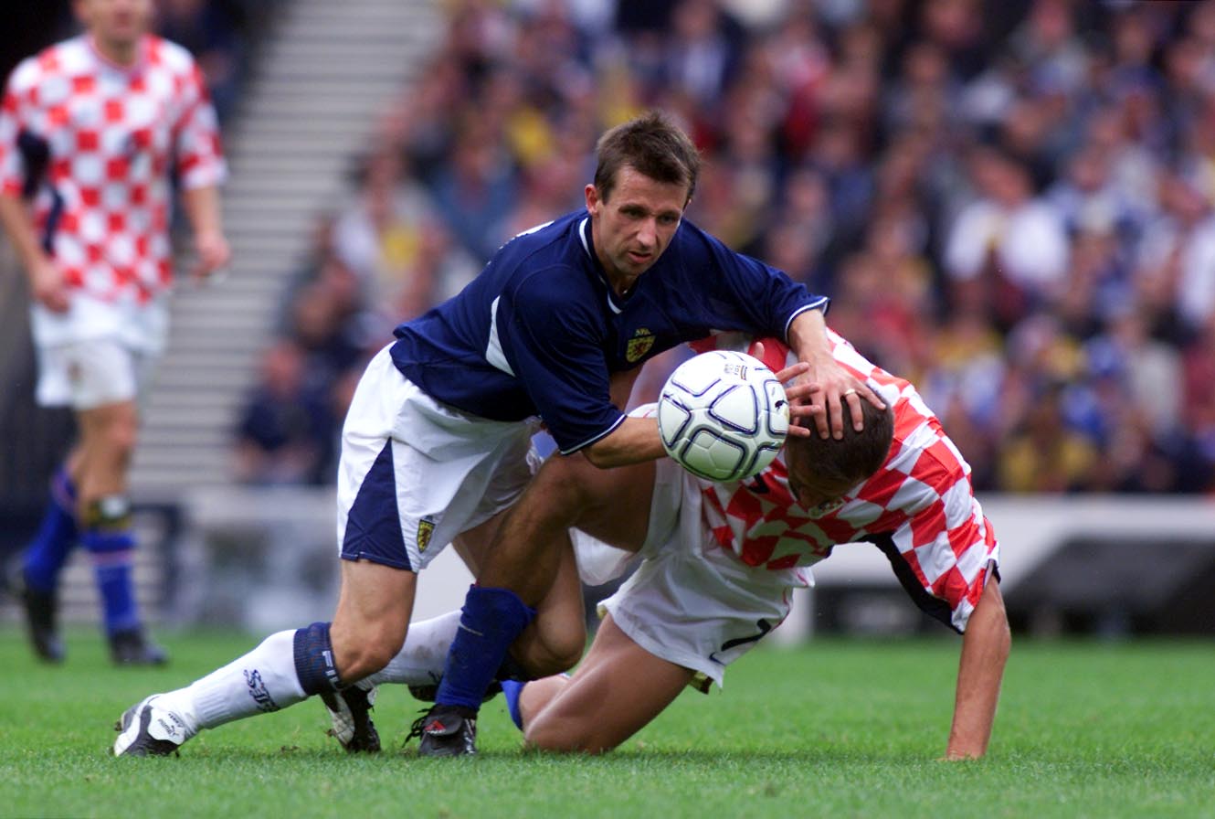 Neil McCann challenges Stjepan Tomas during the Hampden stalemate.