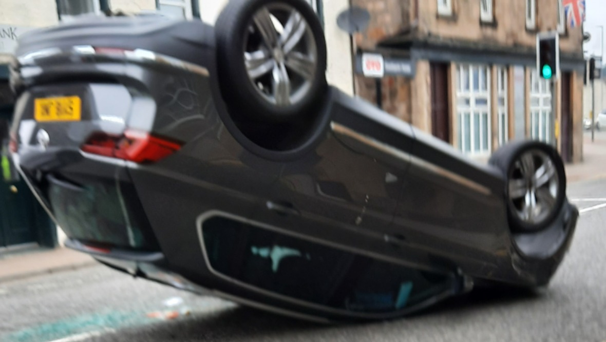 Road reopens after car flips onto its roof in crash