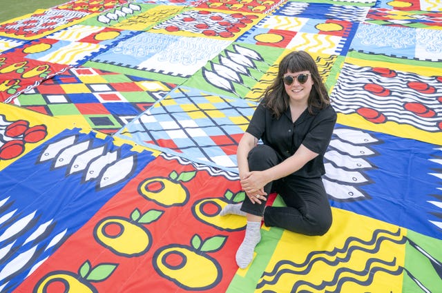 Carnoustie designer Amy Jones, of Dundee Print Collective, with the flags (Jane Barlow/PA)